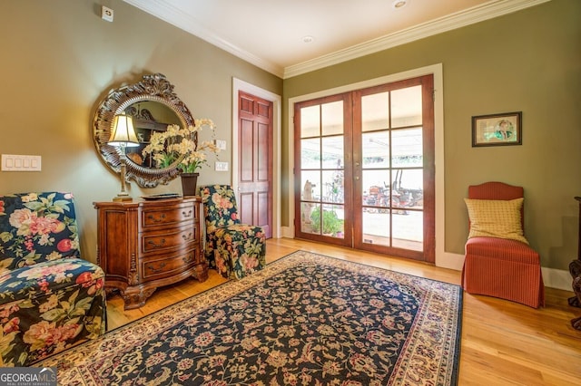 doorway to outside featuring light wood-type flooring, crown molding, and french doors