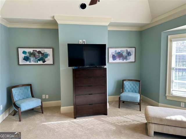 sitting room with lofted ceiling, ornamental molding, and light carpet