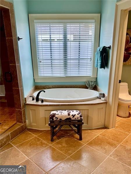 bathroom with tile patterned flooring, toilet, and shower with separate bathtub