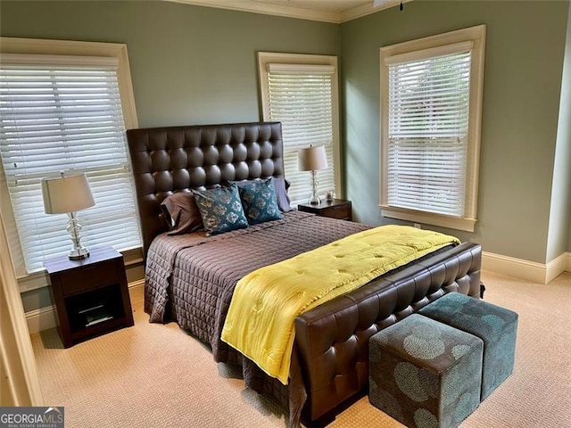 bedroom with light colored carpet and crown molding