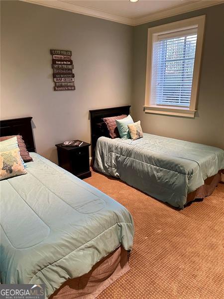 carpeted bedroom featuring crown molding