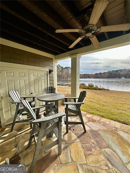 view of patio with a water view