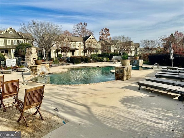 view of pool with pool water feature and a patio area