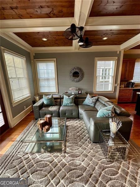 living room with beamed ceiling, hardwood / wood-style floors, and crown molding