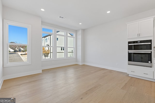 unfurnished living room featuring light hardwood / wood-style flooring