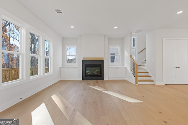 unfurnished living room with light hardwood / wood-style flooring