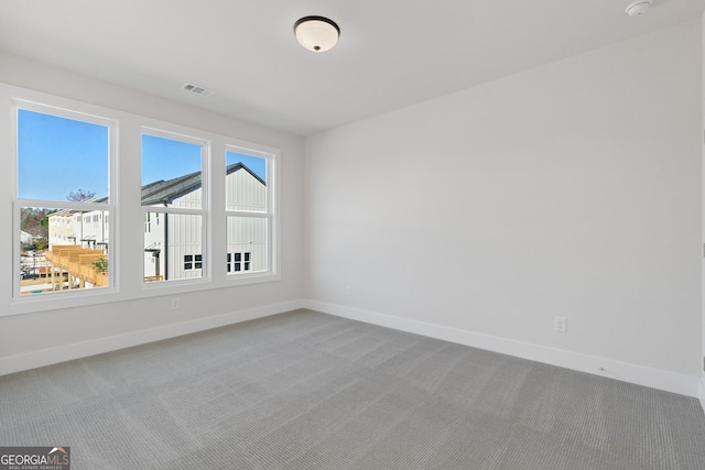 carpeted spare room with a healthy amount of sunlight