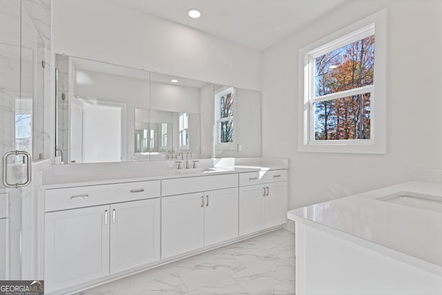 bathroom featuring vanity and an enclosed shower