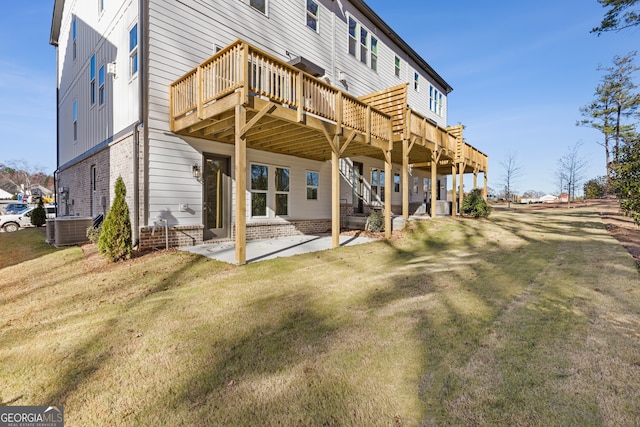 rear view of house with a lawn, a deck, a patio, and central AC