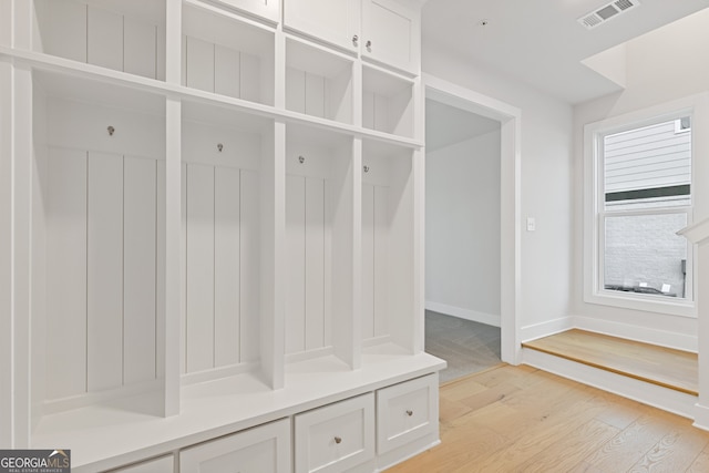 mudroom with light hardwood / wood-style floors