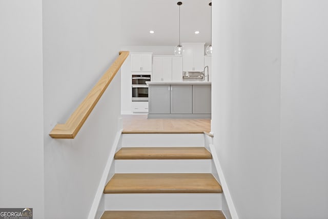 stairway featuring hardwood / wood-style flooring