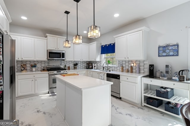 kitchen featuring appliances with stainless steel finishes, a center island, white cabinetry, and hanging light fixtures