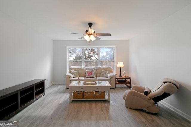 living room with light hardwood / wood-style floors and ceiling fan