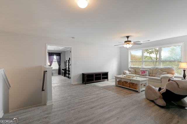 living room featuring ceiling fan and light hardwood / wood-style flooring