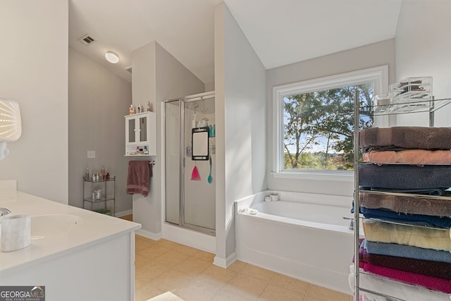 bathroom with plus walk in shower, vanity, and vaulted ceiling