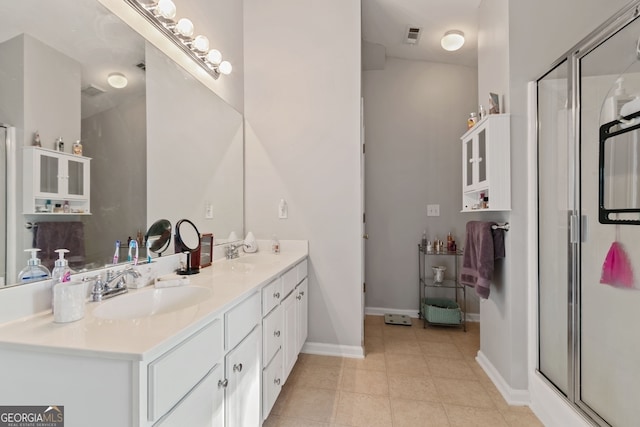 bathroom featuring vanity and a shower with shower door