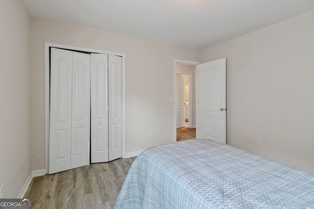 bedroom featuring light wood-type flooring and a closet