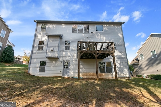 rear view of house featuring a yard