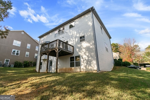 back of house featuring a yard and a deck