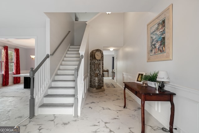 staircase featuring ornamental molding