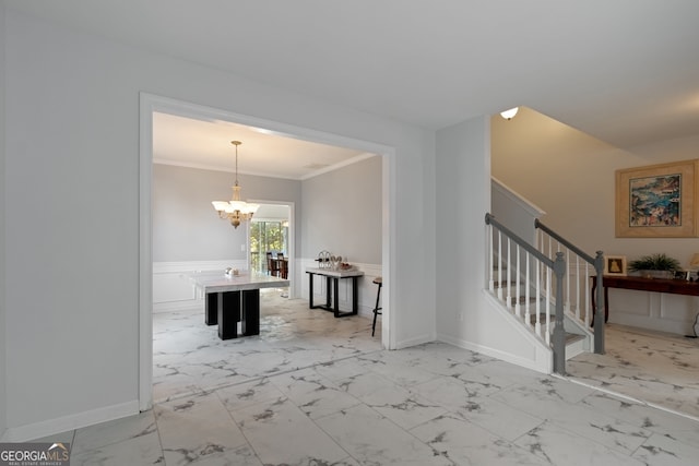 entryway featuring ornamental molding and a chandelier