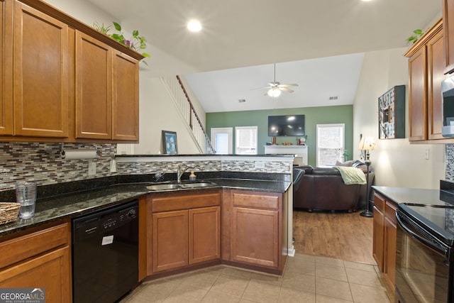 kitchen featuring lofted ceiling, backsplash, black appliances, sink, and ceiling fan