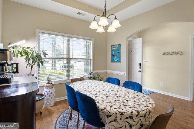 dining space with a chandelier and hardwood / wood-style floors