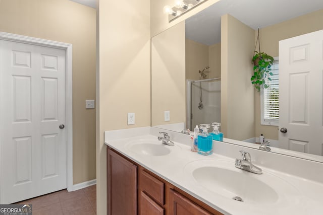 bathroom with tile patterned floors, vanity, and walk in shower