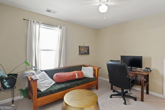 carpeted office featuring ceiling fan