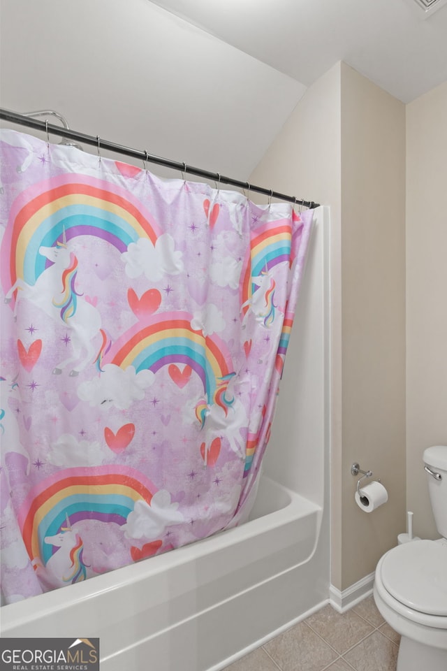 bathroom featuring tile patterned flooring, shower / tub combo, and toilet