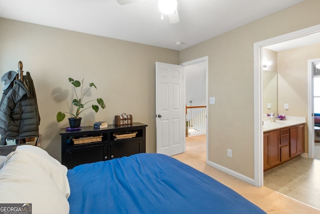 carpeted bedroom featuring ensuite bath and ceiling fan