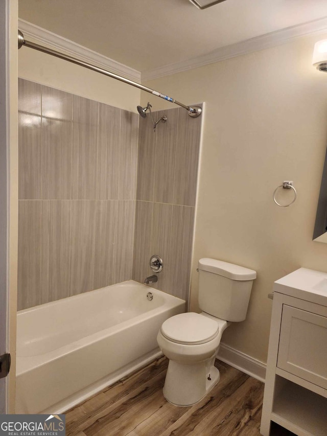 full bathroom with vanity, crown molding, toilet, wood-type flooring, and tub / shower combination