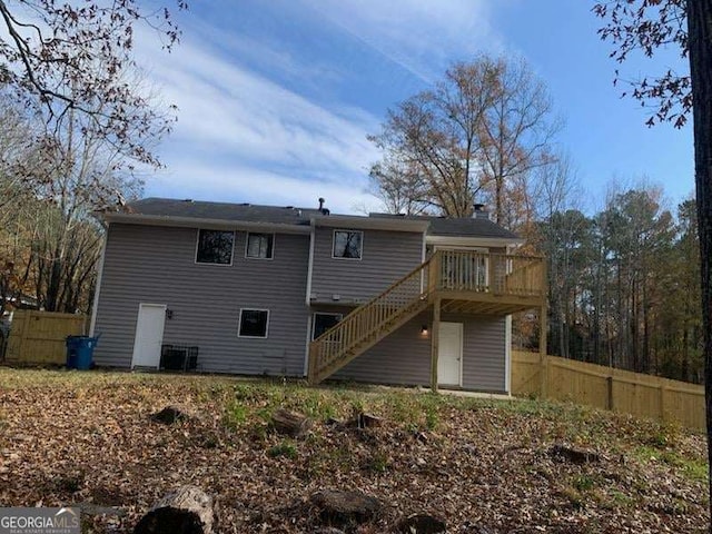 rear view of house featuring a deck