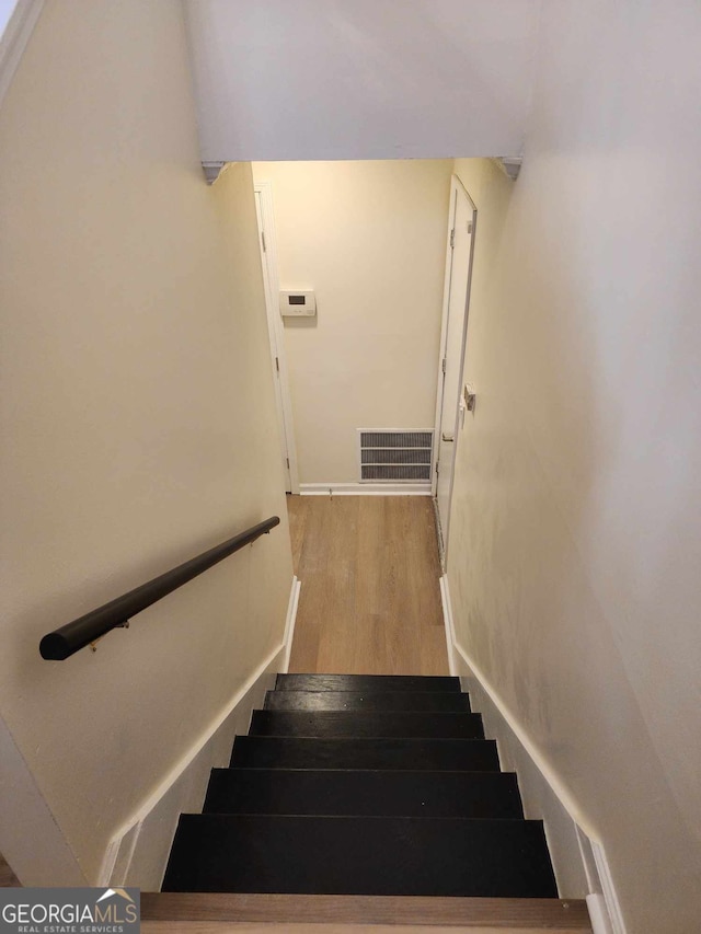 stairs with hardwood / wood-style floors