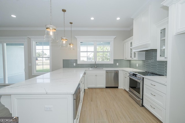 kitchen featuring white cabinets, plenty of natural light, pendant lighting, and appliances with stainless steel finishes