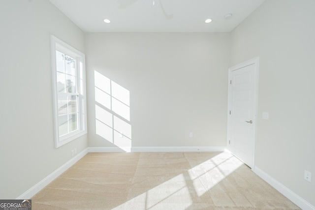 unfurnished room featuring light colored carpet