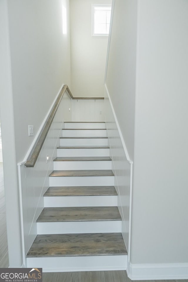 stairway with hardwood / wood-style floors