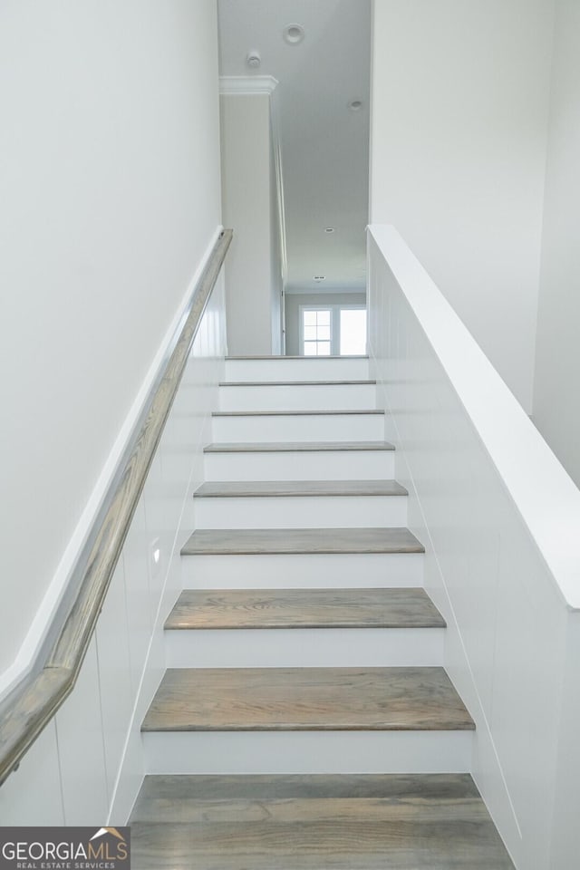 stairs featuring hardwood / wood-style floors