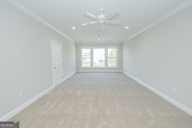 carpeted empty room featuring ceiling fan and ornamental molding