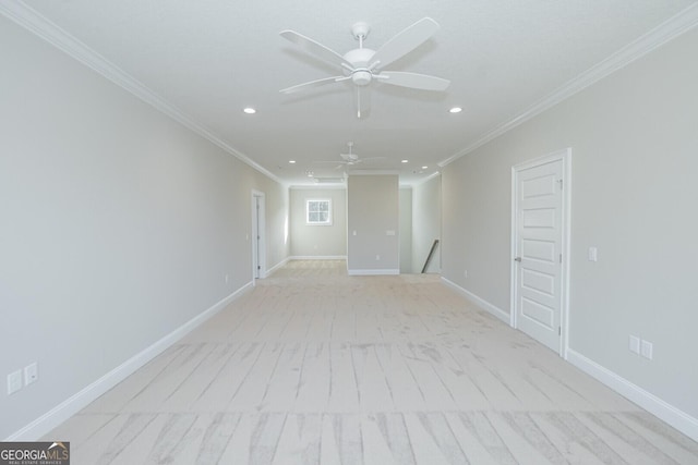 spare room with ceiling fan and crown molding