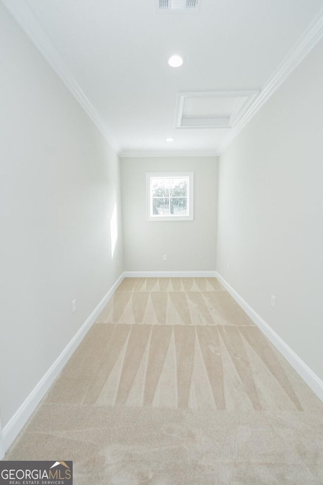 unfurnished room featuring light carpet and crown molding