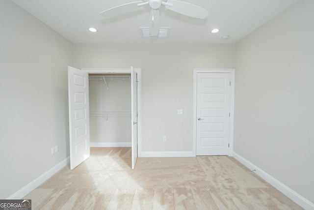 unfurnished bedroom featuring ceiling fan, light carpet, and a closet