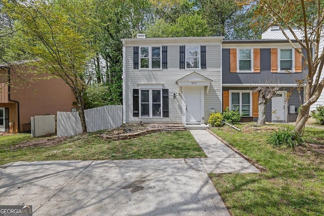 townhome / multi-family property featuring a chimney, a front yard, and fence