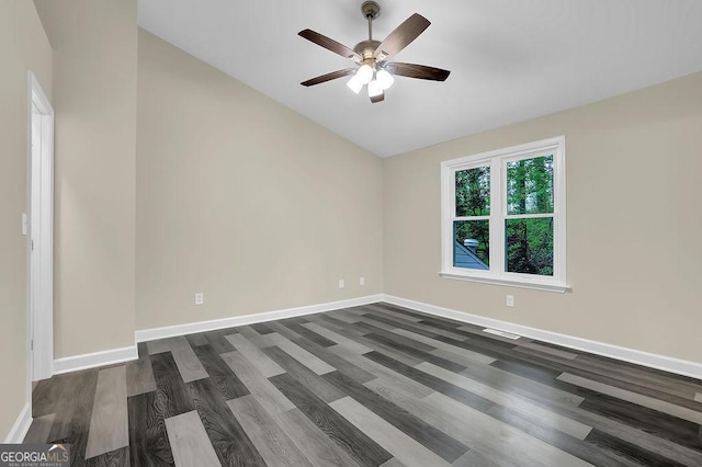 empty room with a ceiling fan, baseboards, and dark wood finished floors