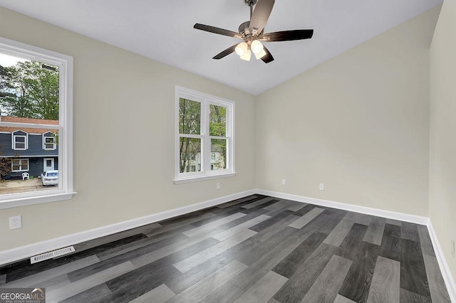unfurnished room with dark wood-type flooring, ceiling fan, baseboards, and visible vents