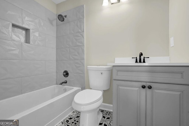 full bath featuring washtub / shower combination, vanity, baseboards, tile patterned floors, and toilet