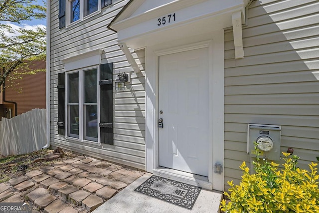 doorway to property with fence