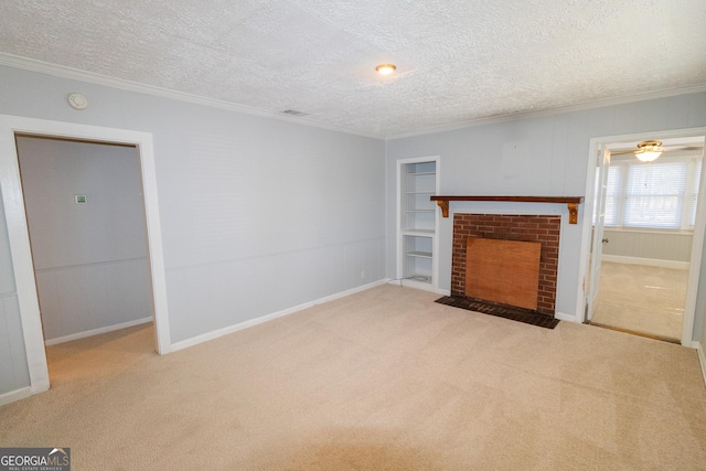 unfurnished living room with a textured ceiling, light colored carpet, a brick fireplace, and crown molding