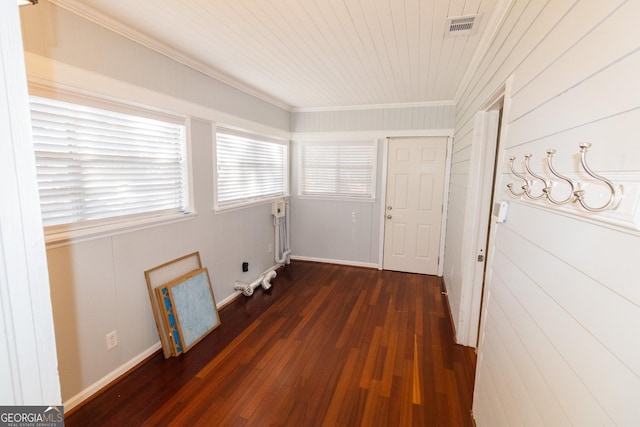 corridor featuring wooden walls, wood ceiling, dark hardwood / wood-style floors, and ornamental molding