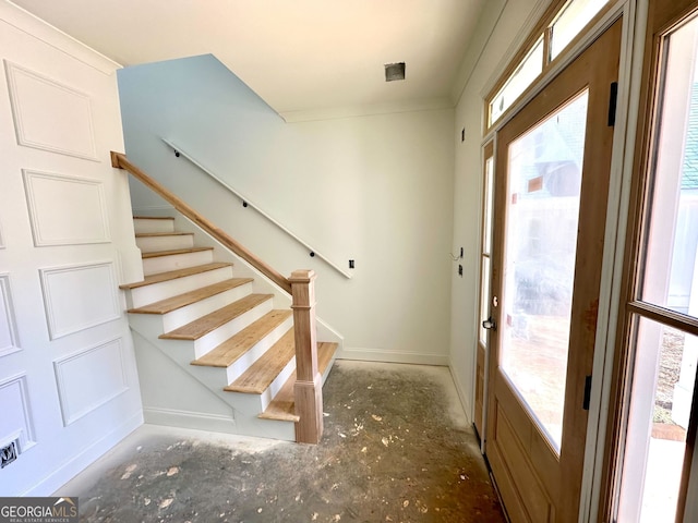 interior space with stairway and baseboards